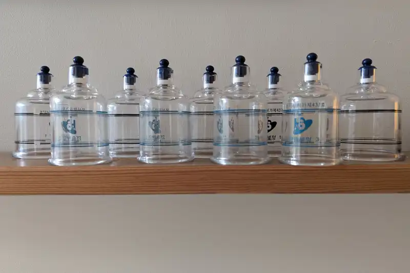 A shelf with many acupuncture cups on it