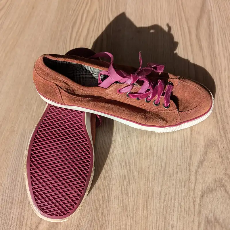 pair of soft soled qi gong shoes sitting on a wooden floor